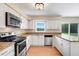 Bright kitchen showcases stainless steel appliances, granite countertops, and a window view at 6720 Midland Drive, St Cloud, FL 34771