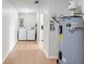 Laundry room features laminate flooring, washer and dryer, and water heater at 6720 Midland Drive, St Cloud, FL 34771