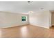 Bright living room featuring wood flooring and a window at 6720 Midland Drive, St Cloud, FL 34771