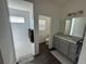 Well-lit bathroom featuring a walk-in shower and a sleek vanity with marble countertop at 862 Bowden Rd, The Villages, FL 32163