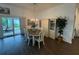 Dining area with stylish lighting and furniture overlooking a screened-in porch at 862 Bowden Rd, The Villages, FL 32163
