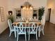 Elegant dining room with stylish table, chairs, chandelier, and decorative shelving unit at 862 Bowden Rd, The Villages, FL 32163