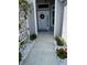 Inviting front entrance features a decorative wreath, lush greenery, and a tiled walkway at 862 Bowden Rd, The Villages, FL 32163
