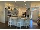Bright kitchen featuring white marble countertops, stainless appliances and three barstool chairs at 862 Bowden Rd, The Villages, FL 32163