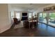 Cozy living room featuring dark wood floors, vaulted ceilings and sliding doors that lead to a patio at 862 Bowden Rd, The Villages, FL 32163