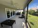 Relaxing screened patio area with seating and hot tub, perfect for outdoor enjoyment at 862 Bowden Rd, The Villages, FL 32163