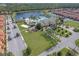 An aerial view showing the community pool, playground, and adjacent lake at 8977 Majesty Palm Rd, Kissimmee, FL 34747