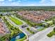 Panoramic aerial view of the community entrance, featuring lush landscaping and serene water features at 8977 Majesty Palm Rd, Kissimmee, FL 34747
