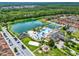 Gorgeous aerial view of clubhouse, lake, pool, and community amenities at 8977 Majesty Palm Rd, Kissimmee, FL 34747