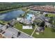 Aerial view showcasing the pool, volleyball court, playground, and lakeside location at 8977 Majesty Palm Rd, Kissimmee, FL 34747