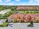 Wide aerial view of the property featuring colorful townhomes and reserved parking spaces at 8977 Majesty Palm Rd, Kissimmee, FL 34747