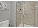 Bathroom featuring a glass-enclosed shower with tile and a toilet at 8977 Majesty Palm Rd, Kissimmee, FL 34747