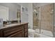 Bathroom showcasing a single vanity with granite countertops and tiled shower at 8977 Majesty Palm Rd, Kissimmee, FL 34747