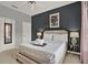 This bedroom has a comfortable bed, soft lamps, and a fun space themed picture frame at 8977 Majesty Palm Rd, Kissimmee, FL 34747
