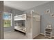 Cozy bedroom with white bunk beds, a window, and a soft carpet at 8977 Majesty Palm Rd, Kissimmee, FL 34747