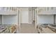 Bright bedroom featuring twin bunk beds, neutral walls, and carpeted floors at 8977 Majesty Palm Rd, Kissimmee, FL 34747