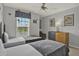 Bedroom with two twin beds, colorful decor, and natural light from a window at 8977 Majesty Palm Rd, Kissimmee, FL 34747