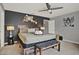 Relaxing bedroom features a headboard wall and a stylish bench at the end of the bed at 8977 Majesty Palm Rd, Kissimmee, FL 34747