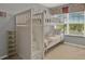 Charming bedroom with white bunk beds and natural light from a window at 8977 Majesty Palm Rd, Kissimmee, FL 34747