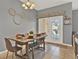 Dining area showcasing a dining table with seating, double doors, and neutral tones at 8977 Majesty Palm Rd, Kissimmee, FL 34747