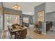 Dining area showcasing a dining table with seating for six, leading to the living room at 8977 Majesty Palm Rd, Kissimmee, FL 34747