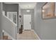 Inviting entryway featuring tile flooring, stairs, and neutral color scheme at 8977 Majesty Palm Rd, Kissimmee, FL 34747