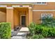 Inviting front porch with elegant columns, bench, and well-maintained landscaping at 8977 Majesty Palm Rd, Kissimmee, FL 34747
