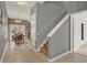 Hallway with staircase, dining room, and view to the backyard at 8977 Majesty Palm Rd, Kissimmee, FL 34747