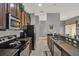 Modern kitchen featuring stainless steel appliances, granite countertops, and a seamless flow to the dining area at 8977 Majesty Palm Rd, Kissimmee, FL 34747