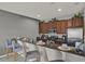 Well-equipped kitchen featuring stainless steel appliances, a breakfast bar, and modern lighting at 8977 Majesty Palm Rd, Kissimmee, FL 34747