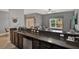 Modern kitchen with stainless steel appliances, granite countertops, and seamless flow to the living space at 8977 Majesty Palm Rd, Kissimmee, FL 34747