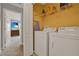 Laundry room equipped with modern appliances, shelving, and storage space at 8977 Majesty Palm Rd, Kissimmee, FL 34747