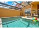 Enclosed pool showcasing clear water, surrounded by a screened-in patio and residential fencing at 8977 Majesty Palm Rd, Kissimmee, FL 34747