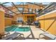 Inviting pool area with a screened-in patio, lounge chairs, and outdoor grill for relaxed living at 8977 Majesty Palm Rd, Kissimmee, FL 34747