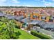 Backyard view showcasing a screened-in pool in a townhome community with colorful exterior paint at 8977 Majesty Palm Rd, Kissimmee, FL 34747