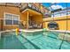 Private screened-in pool with safety fence, outdoor grill, and comfortable seating at 8977 Majesty Palm Rd, Kissimmee, FL 34747