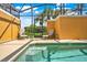 Sun-drenched pool in a screened enclosure with lush green lawn and a view of the surrounding landscape at 8977 Majesty Palm Rd, Kissimmee, FL 34747