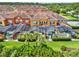 A sunny view of colorful townhomes with screened-in pools and lush landscaping at 8977 Majesty Palm Rd, Kissimmee, FL 34747