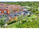 Eye-level view of colorful townhomes featuring screened-in pools and tropical landscaping at 8977 Majesty Palm Rd, Kissimmee, FL 34747
