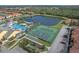 Aerial view of the tennis and basketball courts next to a lake at 8977 Majesty Palm Rd, Kissimmee, FL 34747