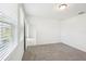 Bright, carpeted bedroom with natural light, and direct access to the bathroom at 903 Donahue Pass, Lake Hamilton, FL 33851