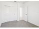 This bedroom features neutral carpeting and paint, complemented by a double door closet for ample storage at 903 Donahue Pass, Lake Hamilton, FL 33851