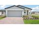 Charming single-Gathering home featuring a two-car garage, stone accents, and a well-manicured lawn at 903 Donahue Pass, Lake Hamilton, FL 33851