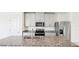 Modern kitchen featuring stainless steel appliances, granite countertops, and stylish gray cabinetry at 903 Donahue Pass, Lake Hamilton, FL 33851