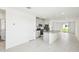 Open-concept kitchen with an island, stainless steel appliances, gray cabinets, and tile flooring at 903 Donahue Pass, Lake Hamilton, FL 33851