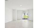 Bright and airy living room with tile flooring and sliding glass doors leading to the backyard at 903 Donahue Pass, Lake Hamilton, FL 33851