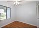 Bedroom featuring laminate floors, window, ceiling fan and built-in closet at 954 Courtyard Ln # 52, Orlando, FL 32825