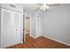 Bright bedroom features wood-look floors and has ample closet space at 954 Courtyard Ln # 52, Orlando, FL 32825