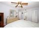Bright bedroom showcasing a dresser, wood-look floors, and ensuite bath access at 954 Courtyard Ln # 52, Orlando, FL 32825