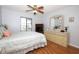 Comfortable bedroom features a large dresser, wood-look flooring and natural light at 954 Courtyard Ln # 52, Orlando, FL 32825